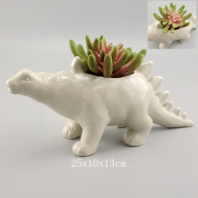 Planteur de dinosaure de stegosaurus de poterie grise avec des plantes